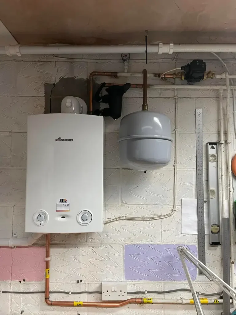 a white boiler with a grey tank and pipes